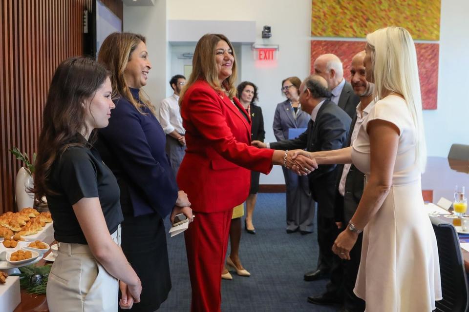 Jitka Putra shaking hands with the president of Miami Dade College in a receiving line